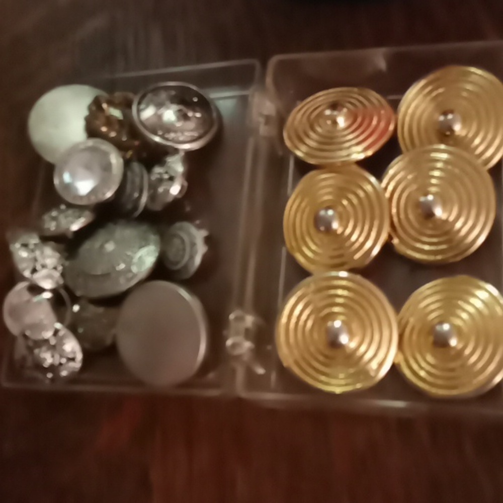 Silver and gold buttons for sewing or crafts.